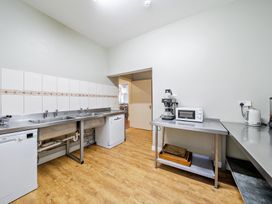 A kitchen with a sink, dishwasher, and countertop at Milton Manor in Milton On Stour