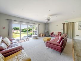 A living room with sofas and a fireplace at Milton Manor in Milton On Stour