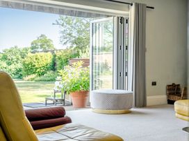 A living room with a view to the garden at Milton Manor in Milton On Stour