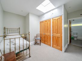 A bedroom with a bed and chair at Milton Manor in Milton On Stour