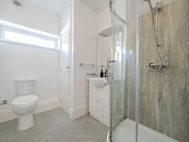 A bathroom with a toilet, sink, and shower at Milton Manor in Milton On Stour
