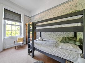 A bedroom with a bunk bed and window at Milton Manor in Milton On Stour