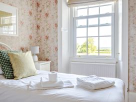 A bedroom with a bed and window at Milton Manor in Milton On Stour