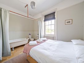 A bathroom with a bathtub and a toilet at Milton Manor in Milton On Stour