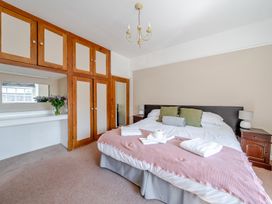 A bedroom with a bed and a mirror at Milton Manor in Milton On Stour