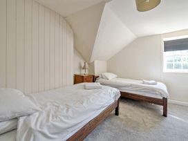 A bedroom with two single beds and a dresser at Milton Manor in Milton On Stour