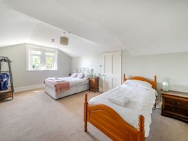A bedroom with two beds and a window at Milton Manor in Milton On Stour