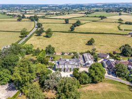 An aerial view of a house surrounded by fields at Milton Manor in Milton On Stour
