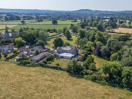 An aerial view of a village with houses and fields at Milton Manor in Milton On Stour