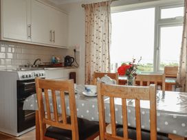 A kitchen with a table and chairs at Little Lanes in Boscastle