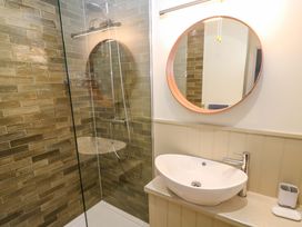 A bathroom with a shower and sink at The Poop Deck in Coverack