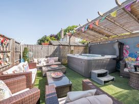 A garden with outdoor seating and a hot tub at The Boars Head Pub in Bishop's Castle