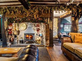 A living room with a fireplace and a sofa at The Boars Head Pub in Bishop's Castle