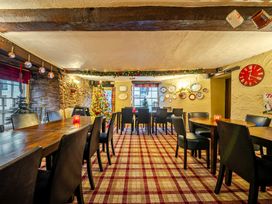 A dining room with wooden tables and chairs at The Boars Head Pub in Bishop's Castle