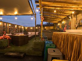 An outdoor seating area with a bar and decorations at The Boars Head Pub in Bishop's Castle