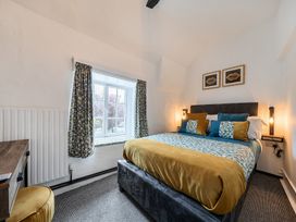 A bedroom with a bed and window at The Boars Head Pub in Bishop's Castle