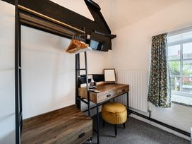 A bedroom with a desk and wardrobe at The Boars Head Pub in Bishop's Castle