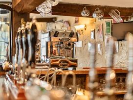 A bar area with an espresso machine and bar taps at The Boars Head Pub Bishop's Castle