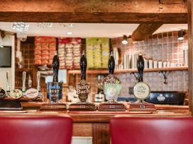 A bar area with beer taps and bottles at The Boars Head Pub in Bishop's Castle