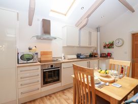 A kitchen with table and chairs at Tregona Buckland Monachorum near Yelverton