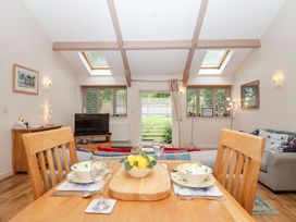 A living room with a dining area and a view of the garden at Tregona Buckland Monachorum near Yelverton