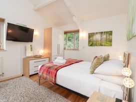 A bedroom with a bed and television at Tregona Buckland Monachorum near Yelverton