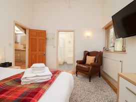 A bedroom with a bed and chair at Tregona Buckland Monachorum near Yelverton