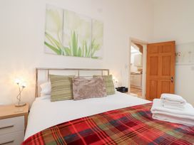 A bedroom with a bed and decorative pillows at Tregona Buckland Monachorum near Yelverton