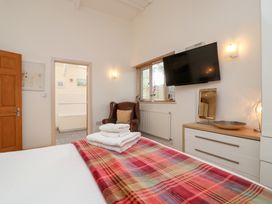 A bedroom with a bed and a television at Tregona Buckland Monachorum near Yelverton