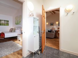 A bedroom with a bed and a doorway leading to a living area at Tregona Buckland Monachorum near Yelverton