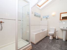 A bathroom with a shower, bathtub, toilet and sink at Tregona Buckland Monachorum near Yelverton