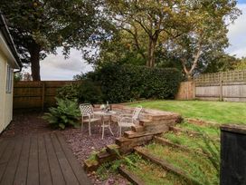 A garden area with a table and chairs at Tregona near Buckland Monachorum