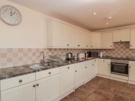A kitchen with a sink and appliances at Bramble Cottage in Somerton