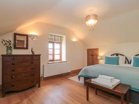 A bedroom with a bed and dresser at Bramble Cottage Somerton