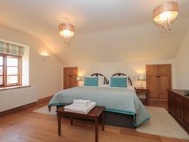 A bedroom with a bed and side table at Bramble Cottage in Somerton
