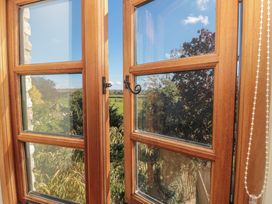 A window view of trees and landscape at Bramble Cottage in Somerton