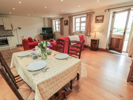 A dining room with a table set for meals at Bramble Cottage Babcary near Lydford-On-Fosse