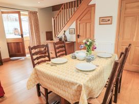 A dining room with a table set for a meal at Bramble Cottage Babcary near Lydford-On-Fosse