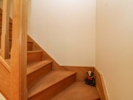 A staircase with a stuffed animal at Badger Cottage in Lydford-On-Fosse