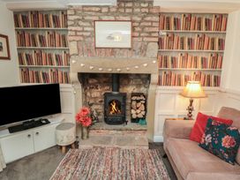 A living room with a fireplace and television at Dove Cottage in Pickering