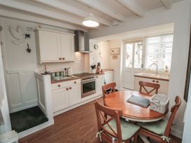 A kitchen with countertops and a dining table at Dove Cottage in Pickering