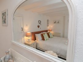 A bedroom with a bed and decorative items at Dove Cottage in Pickering