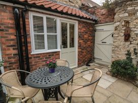 A patio area with a table and chairs at Dove Cottage in Pickering