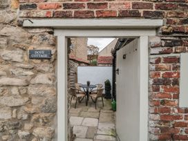 An outdoor area with a table and chairs at Dove Cottage in Pickering