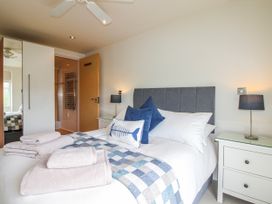 A bedroom with a bed and bedside table at 7 Ocean's Edge in Thurlestone