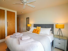 A bedroom with a double bed and nightstand at 7 Ocean's Edge Thurlestone