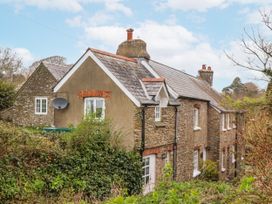 An exterior view of a house with a satellite dish at Yew Tree Cottage in Stoke Fleming