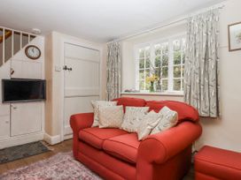 A living room with a sofa and television at Yew Tree Cottage Stoke Fleming