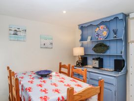A dining room with a table and chairs at Yew Tree Cottage in Stoke Fleming