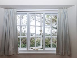 A window with curtains at Yew Tree Cottage Stoke Fleming